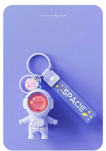 Detailed view of purple astronaut keychain with sunset lamp visor effect and SPACE strap