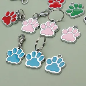 Detail view of various colorful paw print alloy charms for pet ID tags and DIY crafts