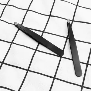 Detailed view of professional black slanted and flat tip stainless steel tweezers