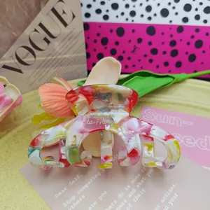 Large colorful acetate French claw clip hair accessory with elegant marble pattern finish