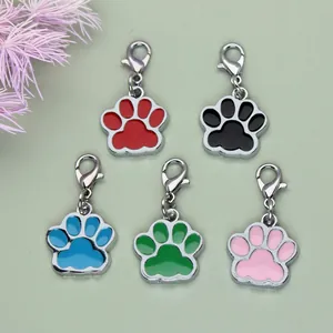 Close-up of colorful alloy paw print charms in red, black, blue, green, and pink for DIY crafts