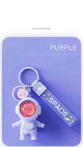 Detailed view of a purple astronaut keychain featuring a sunset lamp charm and space strap