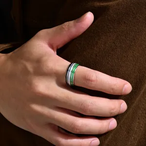 Close-up detail of 8mm stainless steel ring with green and grey pride stripes