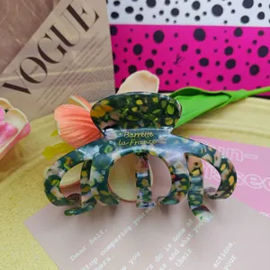 Detail of handmade acetate French hair claw clip with pumpkin mottled pattern
