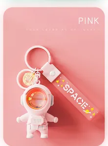 Macro detail of a pink astronaut keychain featuring a sunset lamp effect helmet