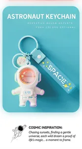 Close-up of white astronaut keychain with sunset lamp effect and blue strap