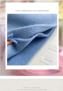 Detailed macro view showing the soft thick light blue plush fabric texture of this winter scarf.