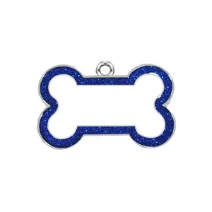 Macro detail of a bone-shaped pet ID tag featuring a vibrant blue glitter border and silver finish