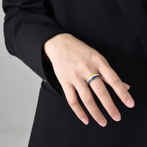 Detailed view of an 8mm wide ring featuring non-binary flag colored stripes on a hand