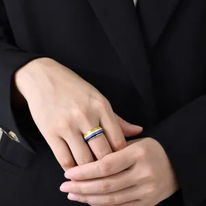 Close-up of person wearing 8mm non-binary pride flag striped ring with black blazer
