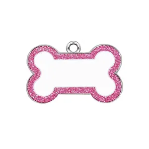 Close-up of bone-shaped pet tag with pink glitter border and blank engraving area