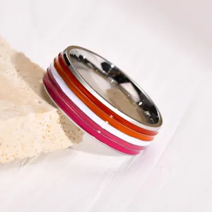 Close-up of 8mm stainless steel ring with vibrant lesbian pride flag enamel stripes