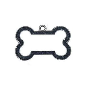 Close-up view of a bone-shaped pet ID tag with dark blue glitter and silver finish.