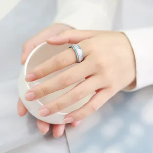 Close-up detail of 8mm colorful transgender pride flag striped ring worn on hand