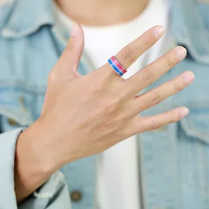 Close-up detail of a colorful 8mm bisexual pride flag striped band ring worn on a finger