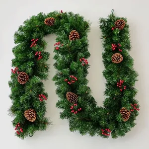 Lush green Christmas garland with realistic pinecones and red berries for festive decor