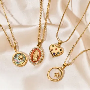 Close-up detail of variety gold-plated stainless steel necklaces on silk fabric