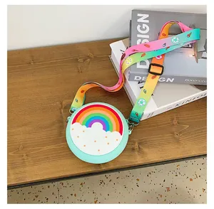 Detail shot of mint green kids silicone crossbody bag with rainbow cloud design
