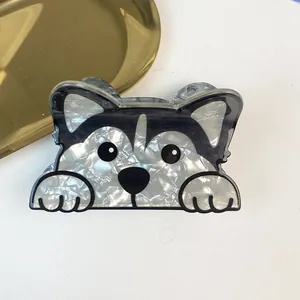 Close-up detail of a cute pearlescent husky dog acetate hair claw clip for women hair