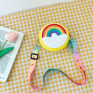 Yellow circular silicone kids crossbody bag with rainbow design and colorful strap