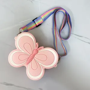 Detailed top view of a pink butterfly shaped silicone mini bag with a rainbow strap