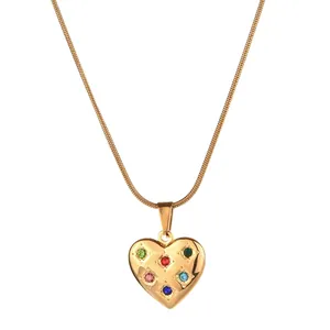Detailed close-up of a gold heart pendant necklace with six colorful crystal stones
