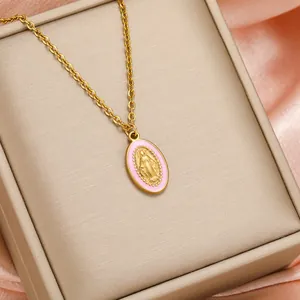 Religious gold-plated Virgin Mary pendant necklace with pink enamel on jewelry box