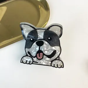 Detailed macro view of French Bulldog acetate hair claw clip with pearlescent white finish