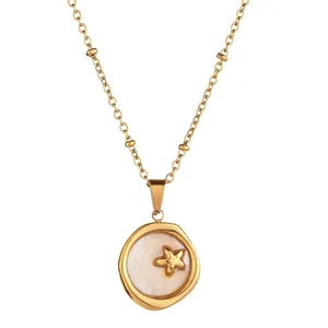 Detail of elegant gold stainless steel necklace with shell inlay and star charm