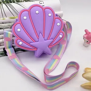 Detailed view of purple shell-shaped silicone children's bag with a rainbow strap