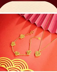Close-up of gold heart necklace and bracelet set with sunburst texture detail