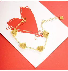 Detailed macro view of a gold heart bracelet with radial textured charms