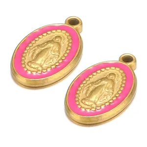 Macro shot of pink enamel Virgin Mary religious pendants with gold-toned metal finish.