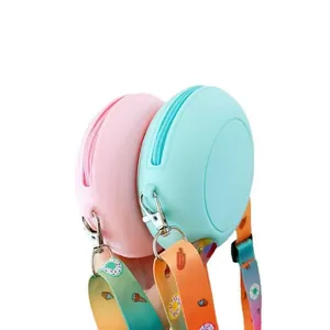 Detailed view of pink and blue silicone mini bags with colorful donut patterned straps