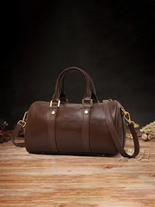 Vintage dark brown Boston pillow bag featuring gold-tone hardware and adjustable strap