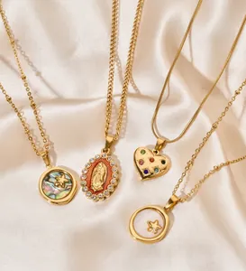 Close-up of elegant gold stainless steel necklaces with heart and shell pendants on silk