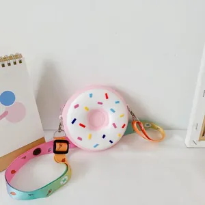 Cute pink donut-shaped silicone crossbody bag for girls with colorful rainbow strap