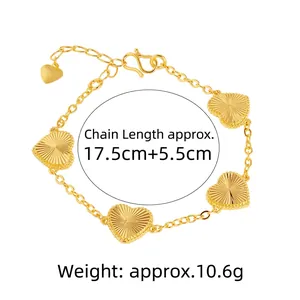 Elegant gold-colored heart charm bracelet featuring sunburst textures and adjustable chain