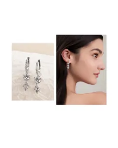 Elegant 925 sterling silver dangle earrings with Moissanite stones shown on a model