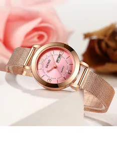 Detailed view of rose gold women's quartz watch with pink dial and mesh strap