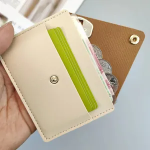 Macro detail showing multiple card slots and coin compartment in a slim beige leather wallet