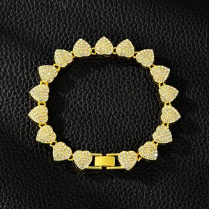 Elegant gold-plated iced-out heart link bracelet for women on black leather background