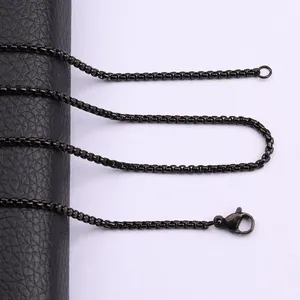 Close-up of black titanium steel box chain showing lobster clasp and matte finish.