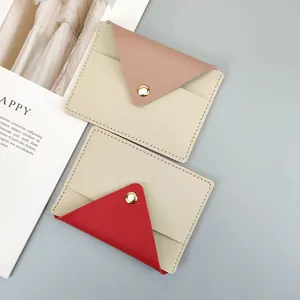 Detail shot of slim faux leather card holders with contrast color envelope flaps