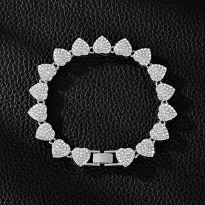 Close-up macro view of a silver heart-shaped bracelet encrusted with sparkling crystals.