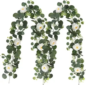 Detailed view of artificial eucalyptus and white rose flower garland for wedding home decor