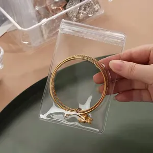 Clear PVC self-sealing bag for jewelry storage shown held by hand to show size and clarity