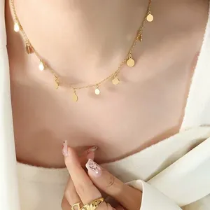 Elegant gold disc charm necklace on model, minimalist stainless steel jewelry accessory