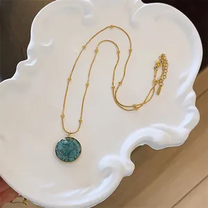 Elegant vintage titanium steel necklace featuring a round turquoise stone mosaic pendant