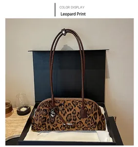 Close-up detail of vintage leopard print Boston bag presented in a black gift box